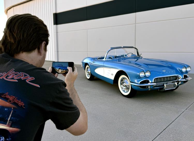 Photographer focusing sports car